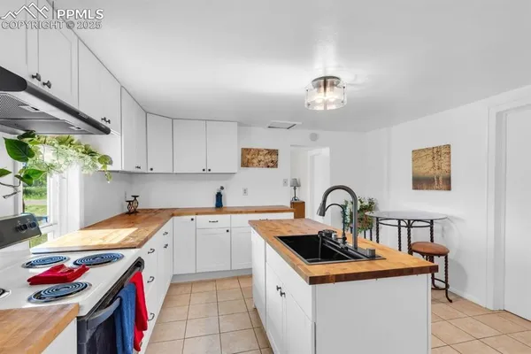 a kitchen with a sink stove and cabinets