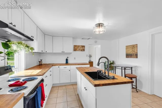 a kitchen with a sink stove and cabinets