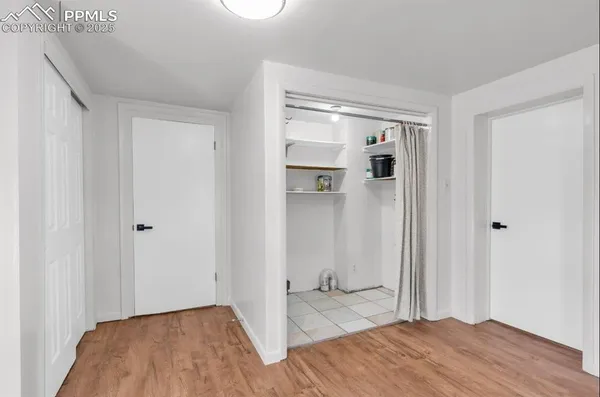 a view of empty room with wooden floor