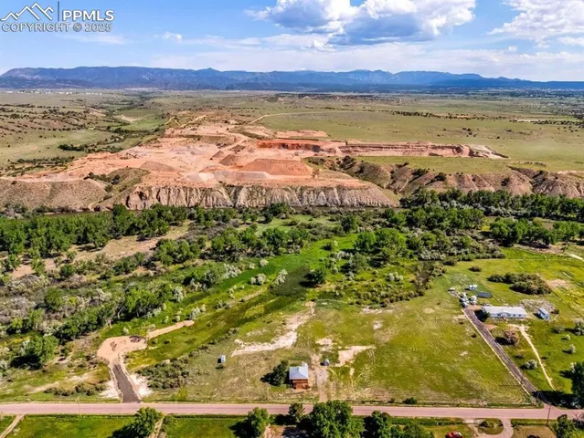 a view of a field with wooden fence