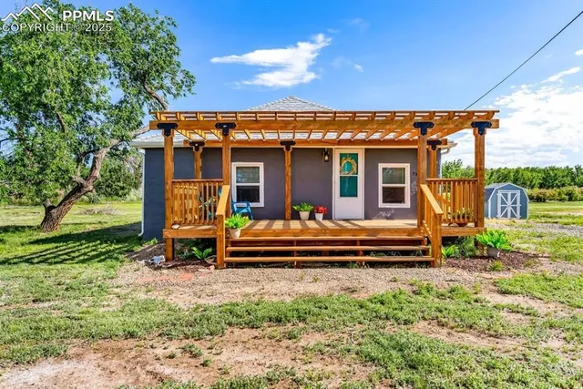 a view of a house with backyard porch and sitting area