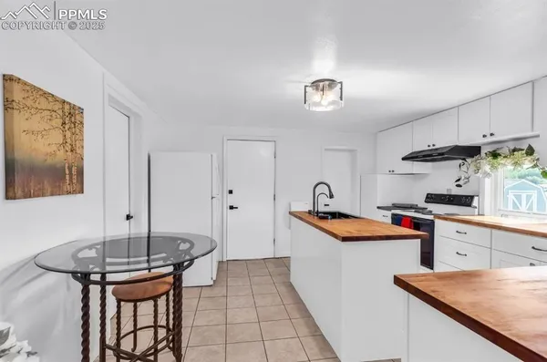 a kitchen with stainless steel appliances granite countertop a sink and a refrigerator