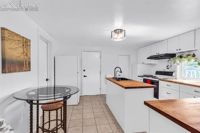a kitchen with stainless steel appliances granite countertop a sink and a refrigerator