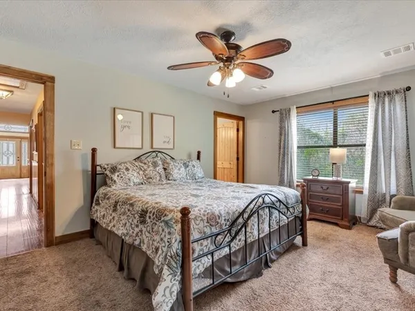 a bedroom with a bed and a chandelier