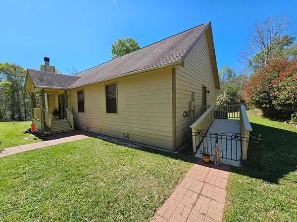 a backyard of a house with table and chairs