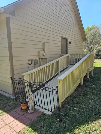 a view of balcony with wooden floor and fence