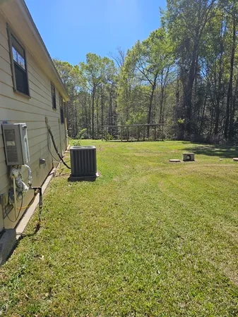 a view of a backyard with swimming pool