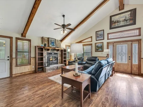 a living room with fireplace furniture and a wooden floor