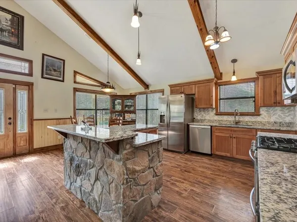 a kitchen with a sink a counter top space and appliances