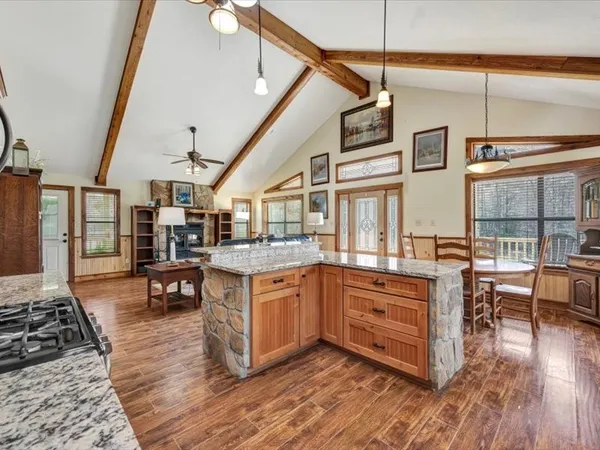 a kitchen with stainless steel appliances granite countertop a stove and cabinets with wooden floor