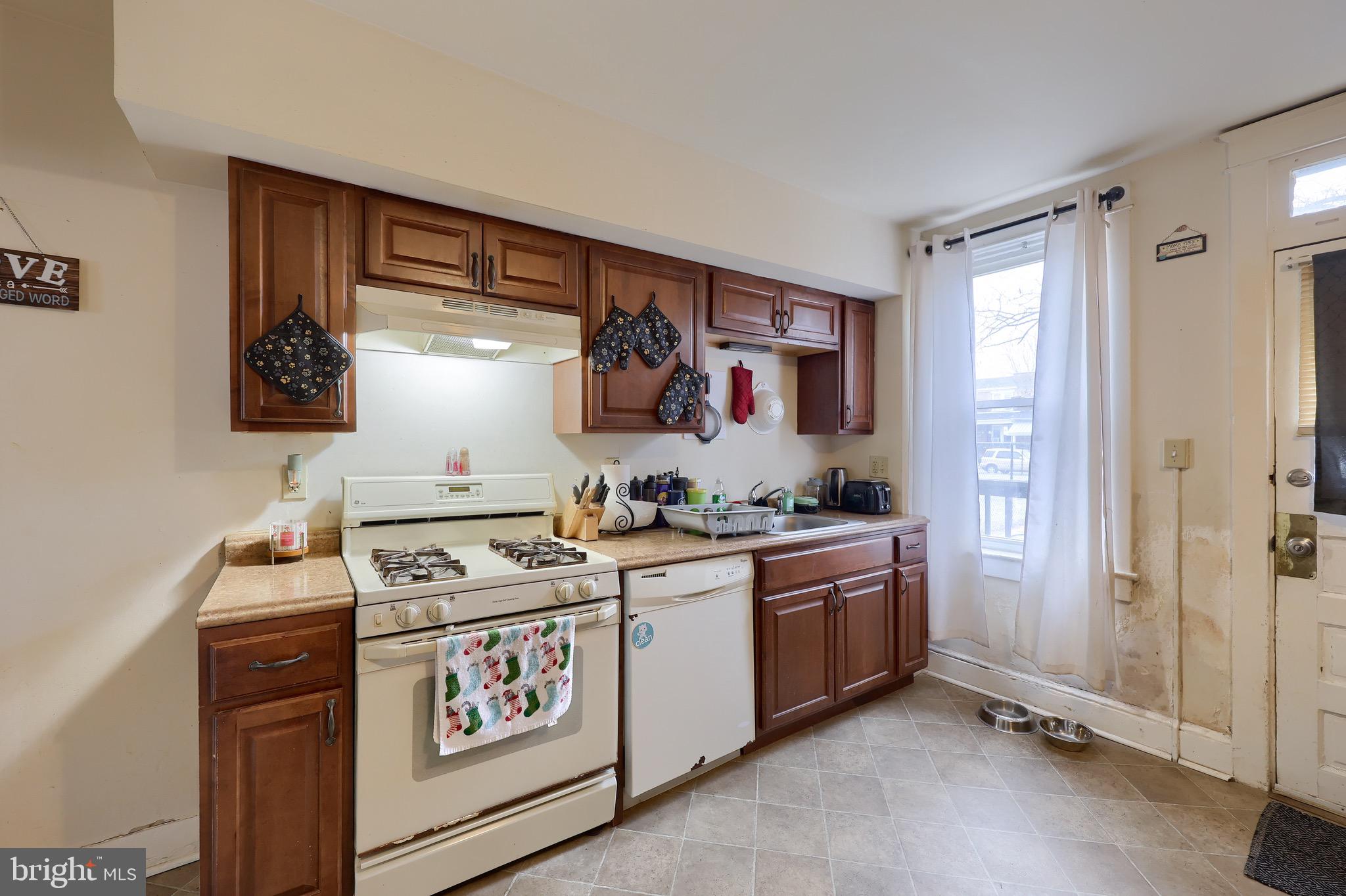 318 East Liberty Street Lancaster, PA 17602 - Photo 7 of 18 a kitchen with stainless steel appliances granite countertop a stove and a sink