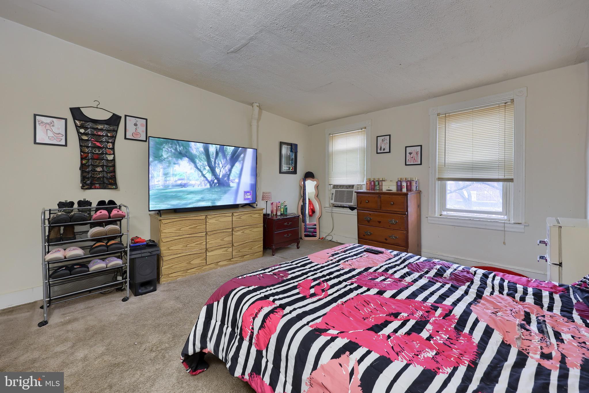318 East Liberty Street Lancaster, PA 17602 - Photo 10 of 18 a bedroom with a bed and a flat screen tv