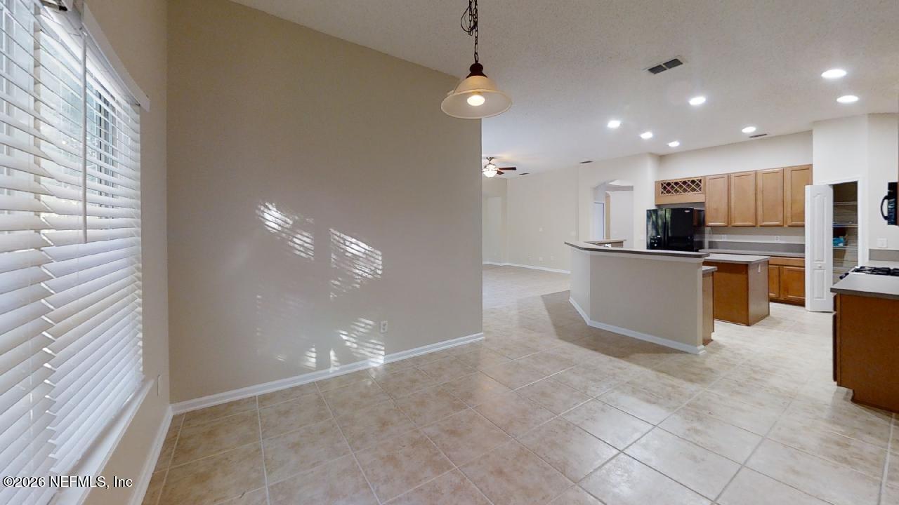 14454 Millhopper Road Jacksonville, FL 32258 - Photo 17 of 44 a view of a kitchen with microwave and cabinets