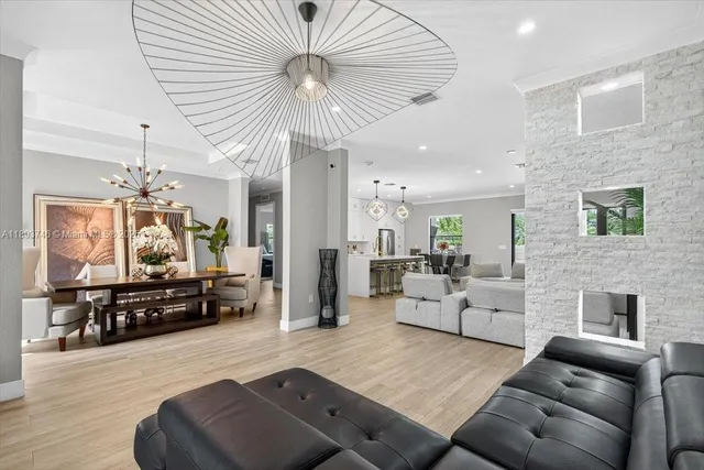a dining room with furniture entryway and wooden floor