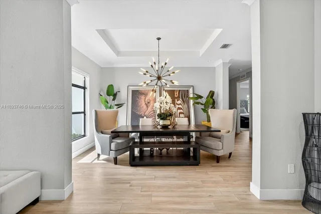 a living room with furniture potted plant and a chandelier