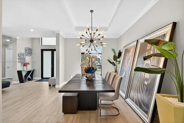 a living room with kitchen island furniture and a chandelier