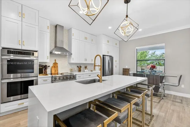 a kitchen with stove a sink and refrigerator