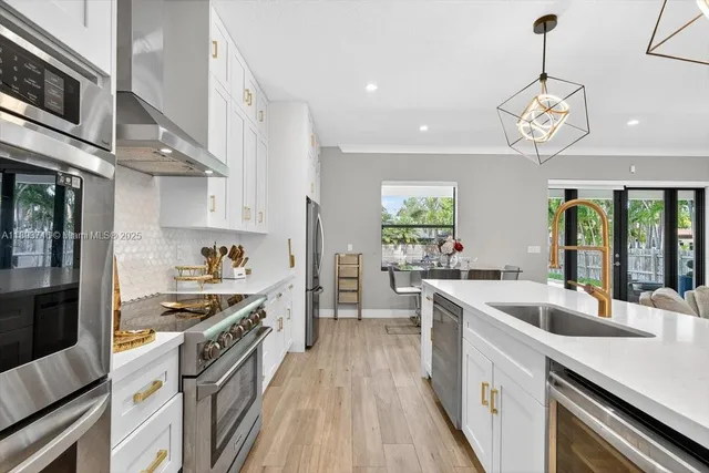 a living room with furniture kitchen and a large window