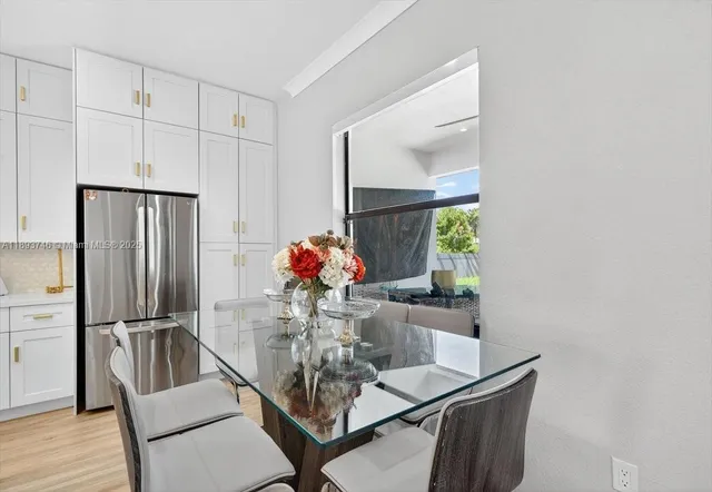 a living room with furniture and kitchen view
