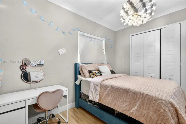 a bedroom with a bed and a chandelier