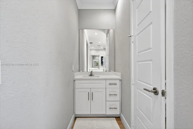 a view of swimming pool with seating space and trees in the background