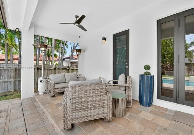 a view of house with swimming pool next to a big yard