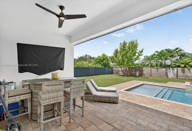 a view of a house with swimming pool and sitting area