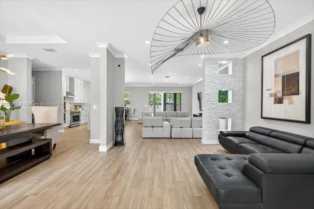 a view of a dining room with furniture and chandelier