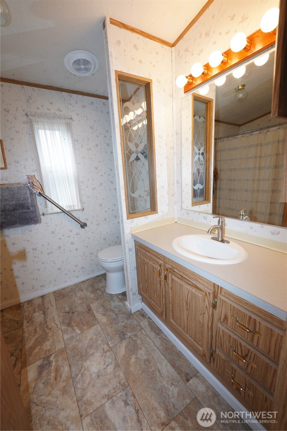 27509 Q Lane Ocean Park, WA 98640 - Photo 13 of 20 a bathroom with a sink a toilet and mirror