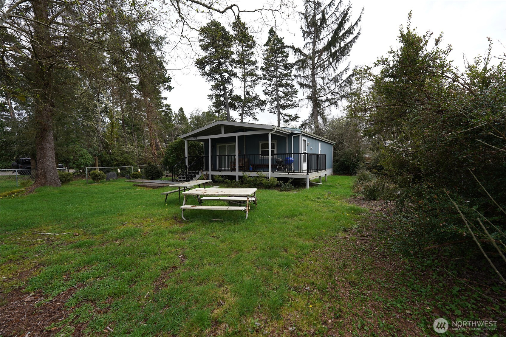 27509 Q Lane Ocean Park, WA 98640 - Photo 15 of 20 a white house with a big yard and large trees