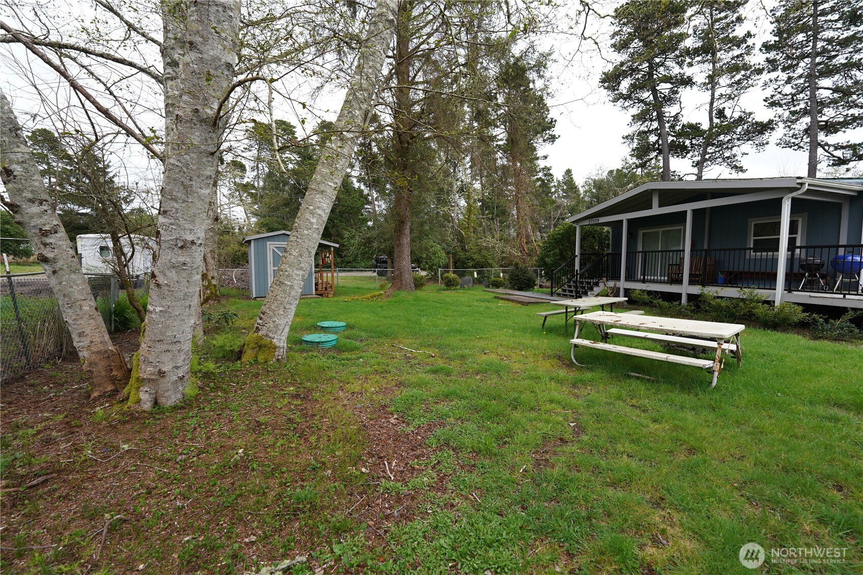 27509 Q Lane Ocean Park, WA 98640 - Photo 16 of 20 a view of a house with a backyard and a tree