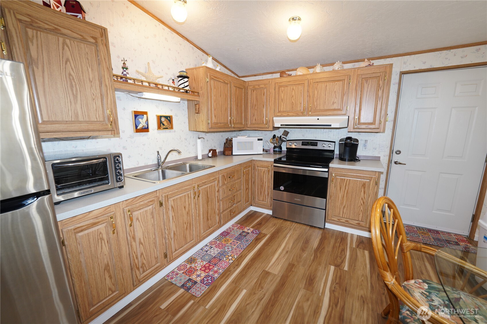 27509 Q Lane Ocean Park, WA 98640 - Photo 9 of 20 a kitchen with granite countertop a refrigerator stove and sink