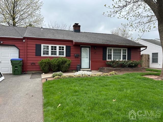 35 Weldon Road Edison, NJ 08817 - Photo 2 of 2 a front view of a house with a yard and garage