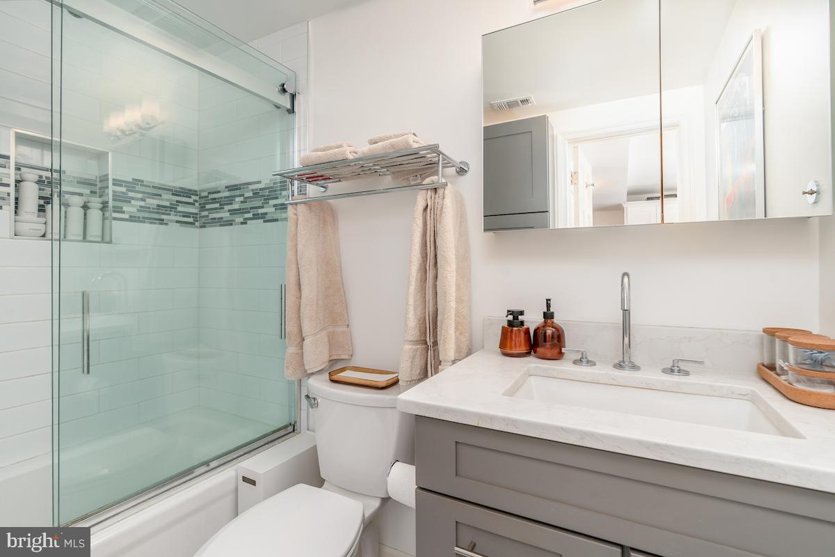 1930 18th Street Northwest, Unit 32 Washington, DC 20009 - Photo 12 of 17 a bathroom with a sink a toilet and shower