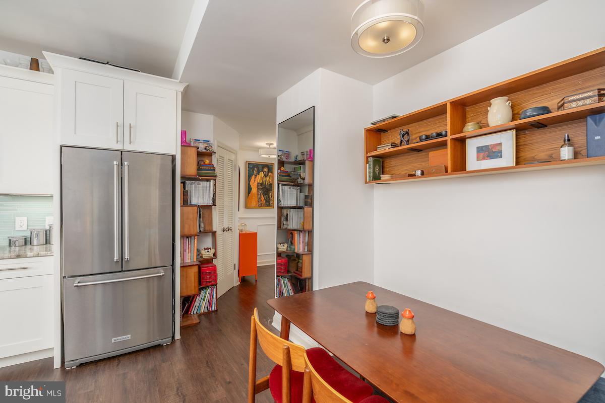 1930 18th Street Northwest, Unit 32 Washington, DC 20009 - Photo 3 of 17 a kitchen with stainless steel appliances a refrigerator and a hard wood floor