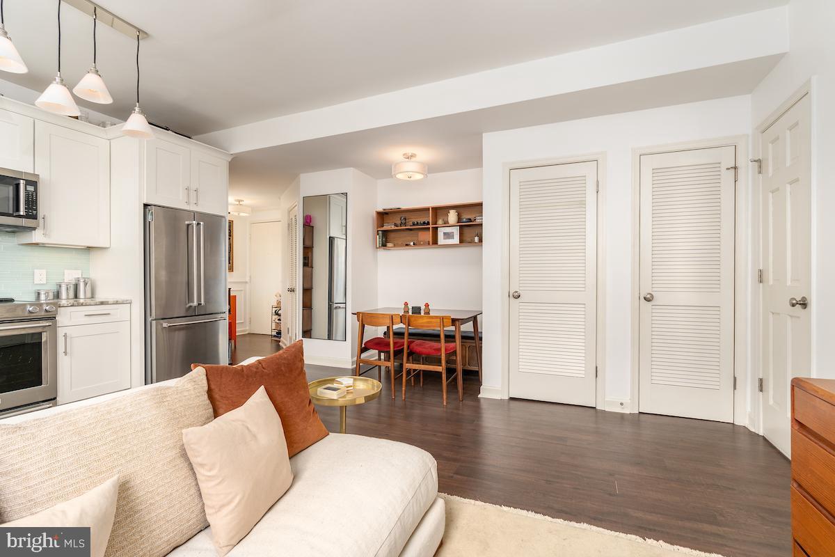1930 18th Street Northwest, Unit 32 Washington, DC 20009 - Photo 10 of 17 a living room with furniture wooden floor and a kitchen view