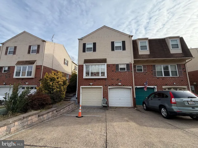 a car parked in front of a white house