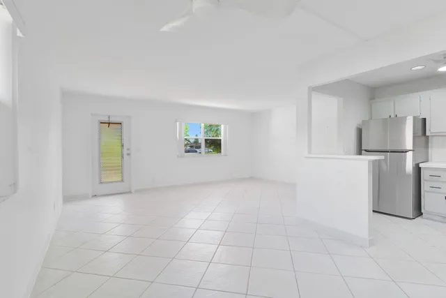 a view of a kitchen with a sink and a refrigerator