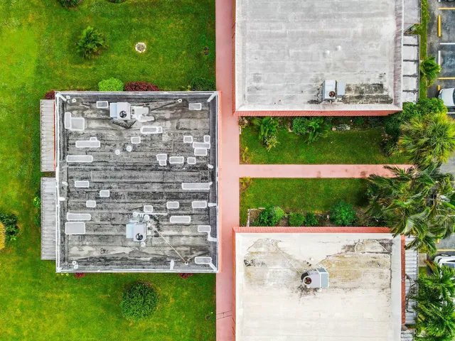 an aerial view of a house with a big yard