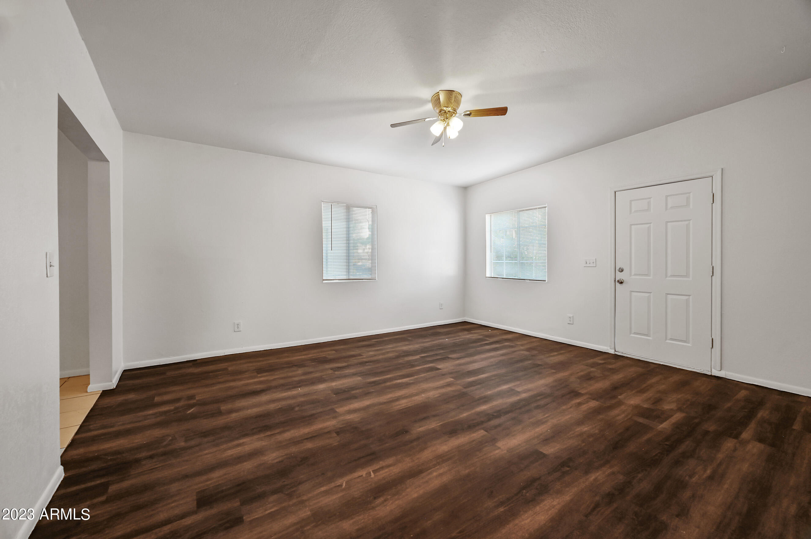 5327 East Taylor Street, Unit A Phoenix, AZ 85008 - Photo 3 of 11 a view of empty room with wooden floor and fan