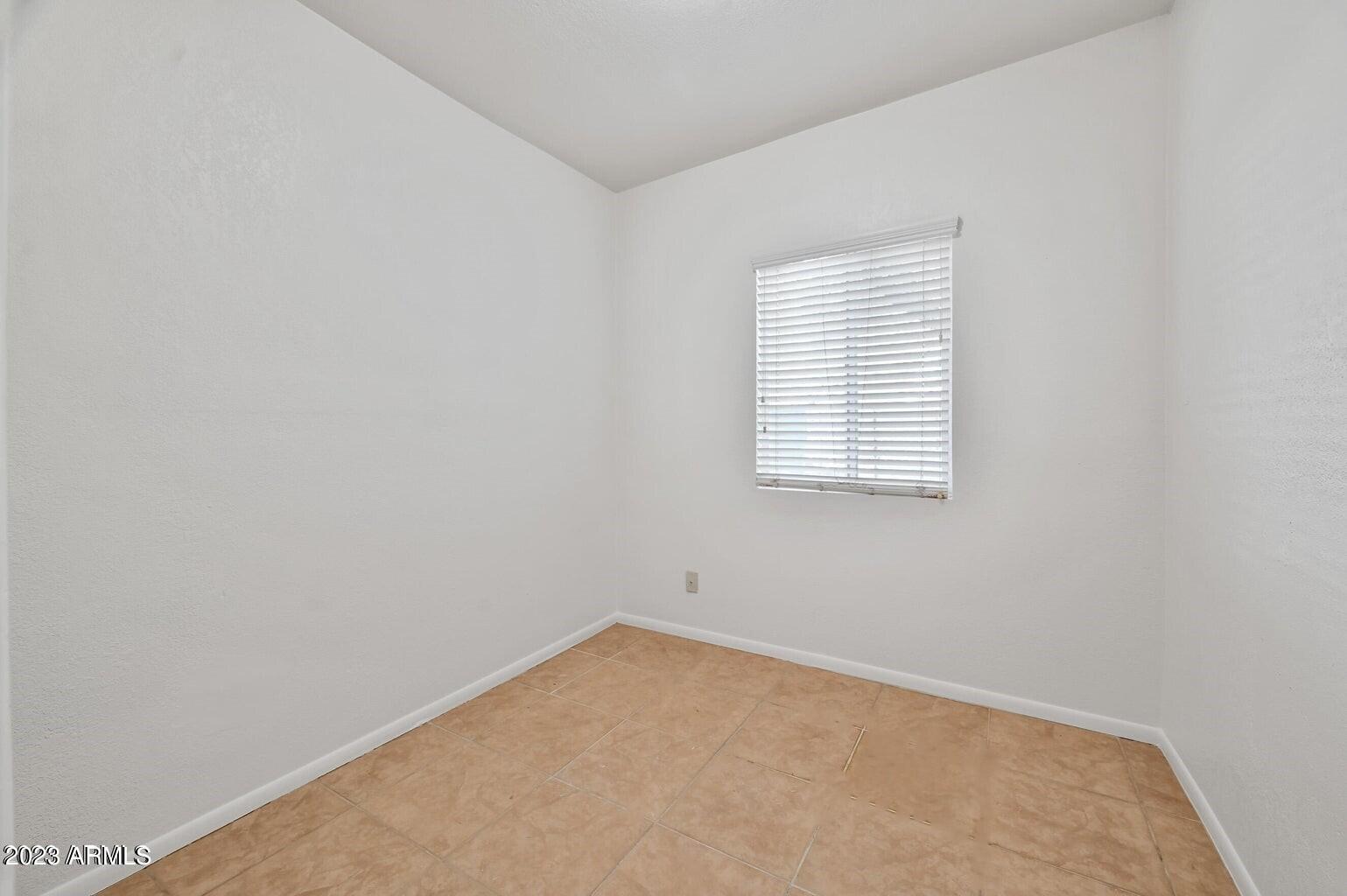 5327 East Taylor Street, Unit A Phoenix, AZ 85008 - Photo 10 of 11 an empty room with a window