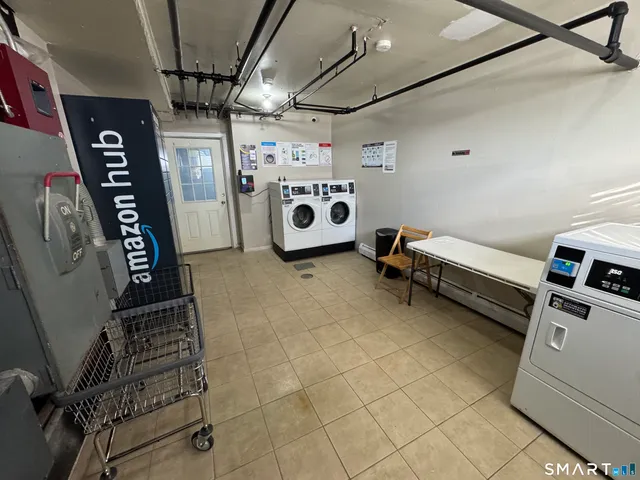 a utility room with multiple dryer and washer