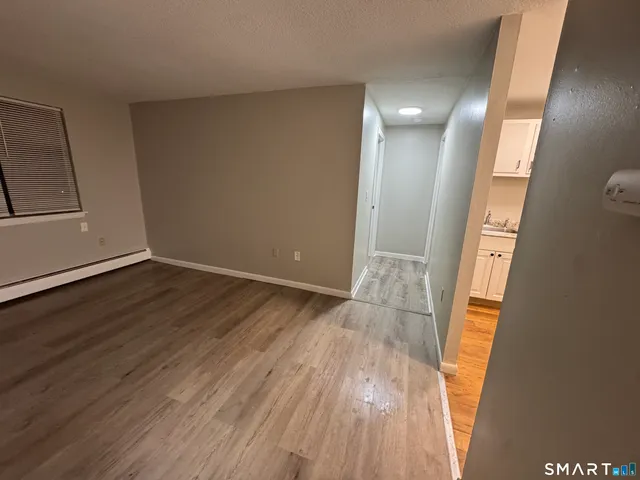 a view of hallway with wooden floor