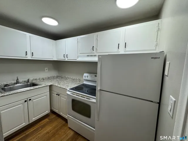 a kitchen with cabinets appliances and a sink