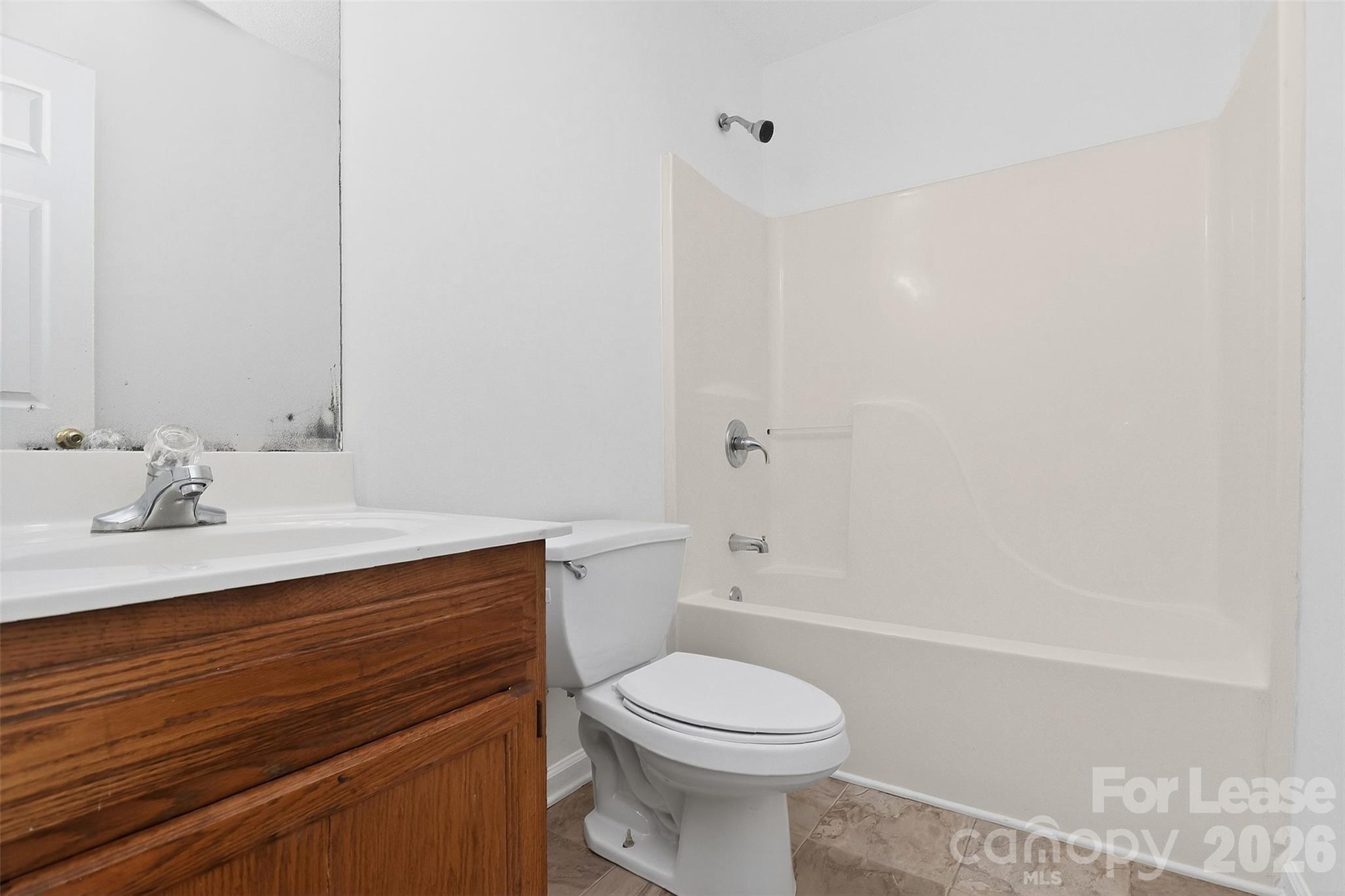 91-93 Sunderland Road Southwest, Unit 93 Concord, NC 28027 - Photo 19 of 30 a bathroom with a sink a toilet and shower