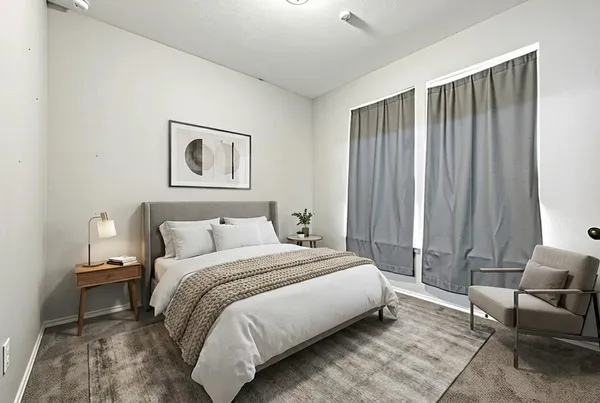 a bedroom with bed and a chair
