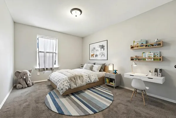 a bedroom with a bed and a chair