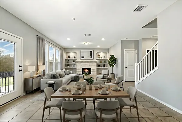 a view of a dining room with furniture and a potted plant