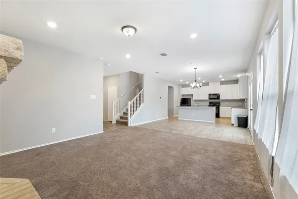 a view of a kitchen with a sink and a stove top oven