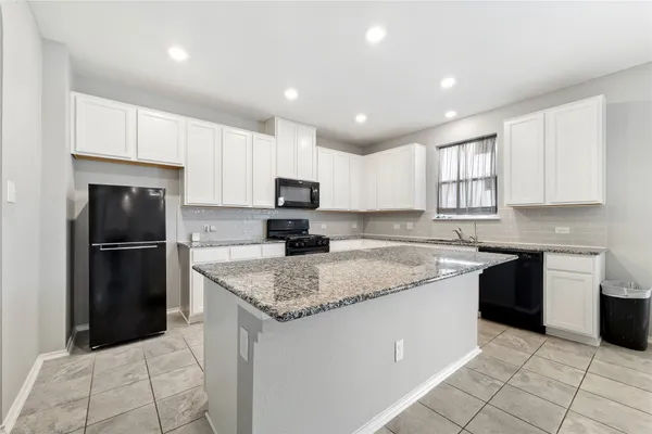 a kitchen with a sink a stove a refrigerator and a sink